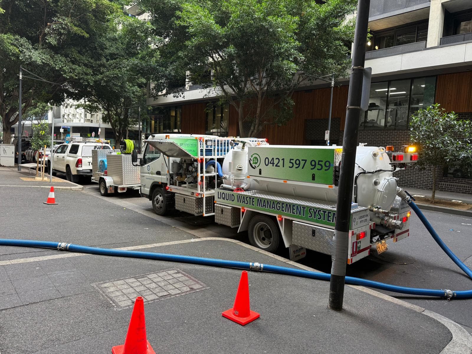 Liquid Vac vacuum truck and support vehicles staged at an inner-city service site