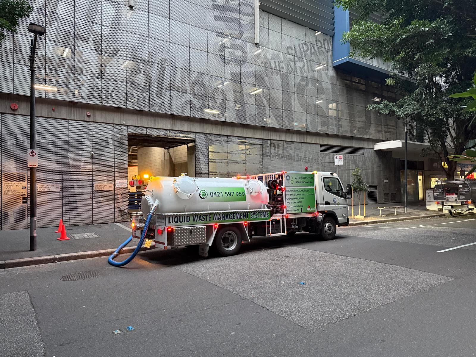 Liquid Vac vacuum truck positioned outside a city loading bay after hours