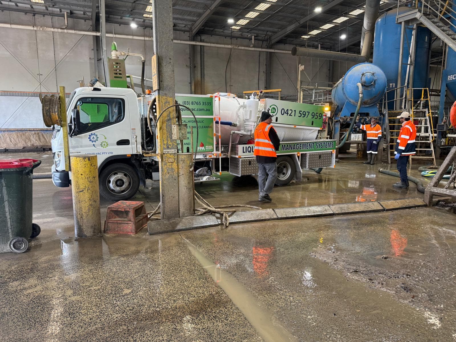 Liquid Vac crew and vacuum truck working inside an industrial facility